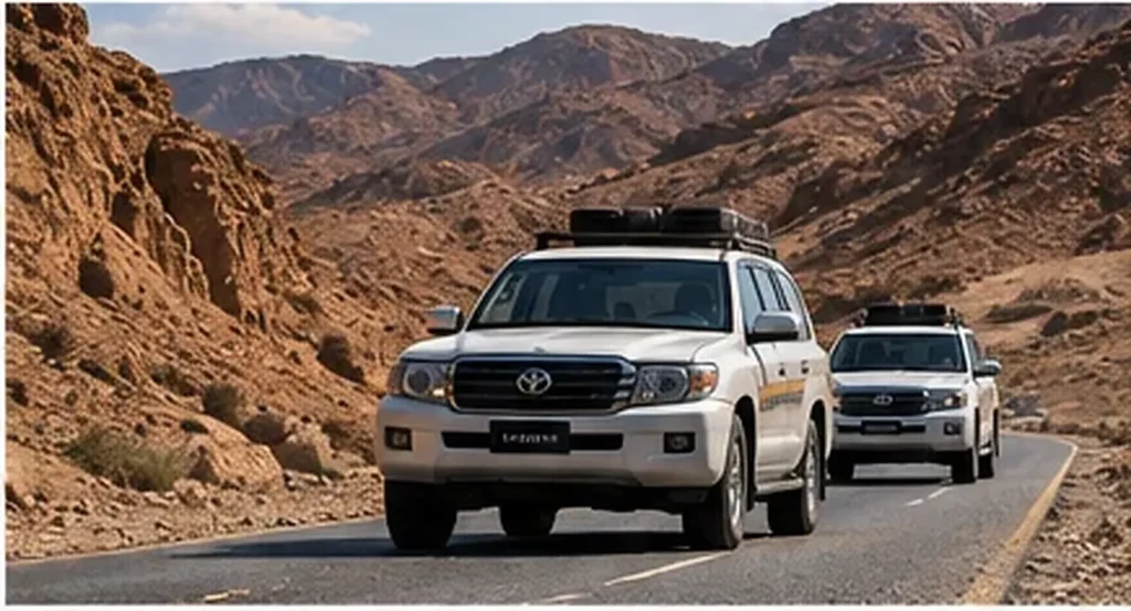 Two four-wheel-drive vehicles on a mountain road, illustrating journey management