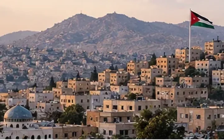 Hillside view of Amman, Jordan, with the Jordanian flag